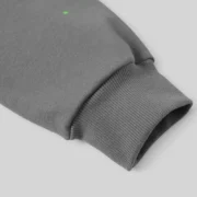 Close-up view of the ribbed sleeve cuff on the grey Sp5der Punk V2 hoodie featuring a signature star graphic detail.