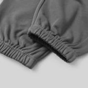 Close-up view of the premium elasticized cuffs on the grey Sp5der Punk V2 sweatpants made from heavyweight cotton.