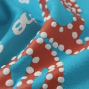 Close-up view of the sky blue Sp5der Punk V2 sweatpants fabric with signature puff print and brand graphic detailing.