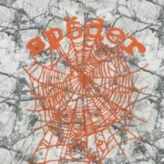Close-up of the Sp5der Realtree OG Web V2 Zip Hoodie featuring a signature orange web graphic on white camo fabric.