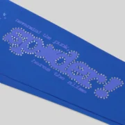 Close-up of the blue Sp5der Rhinestone Punk V2 sweatpants featuring iced-out rhinestone text and star graphic details.