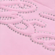 Close-up of the light pink Sp5der zip hoodie showcasing the signature sparkling rhinestone script logo detail.