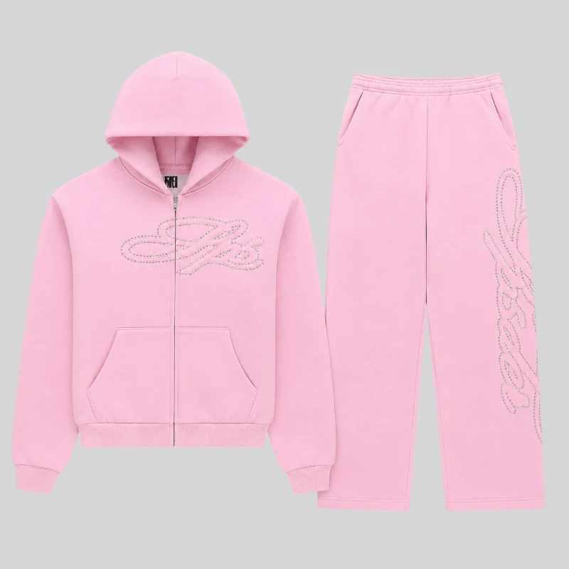 Front view of the Sp5der Rhinestone Script Zip Tracksuit in Light Pink featuring sparkling rhinestone logo details.