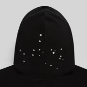 A closeup of the black Sp5der Rhinestone Silk Hoodie hood featuring scattered sparkling rhinestone embellishments.