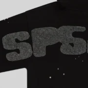 Close-up view of the Sp5der Rhinestone Silk Hoodie in black showing the detailed rhinestone graphic design on the fabric.