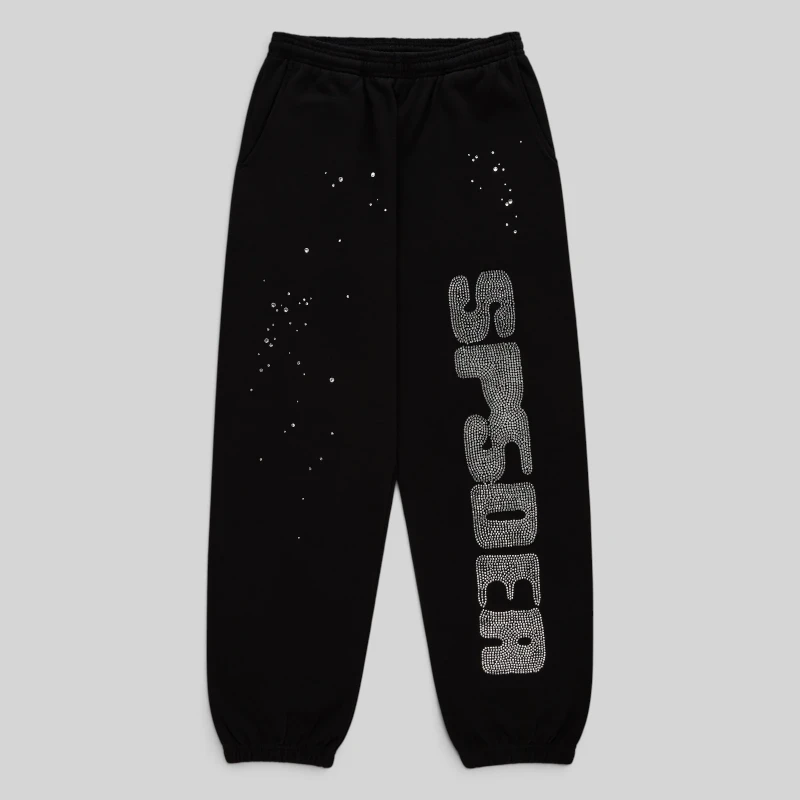 Front view of black Sp5der rhinestone silk sweatpants with branded detailing and scattered crystal accents