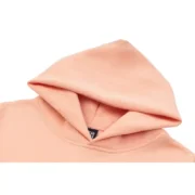 Close-up view of the hood on a premium Sp5der SP5 Bellini hoodie in a soft baby-pink colorway for street style.