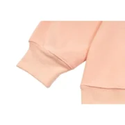 Close-up view of the premium fabric and cuff detail on the Sp5der SP5 Bellini Hoodie in a soft baby-pink colorway.