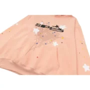 Sp5der SP5 Bellini Hoodie in Baby Pink featuring the iconic street style spiderweb and colorful star graphic design.