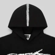 Closeup of the Sp5der Screaming Eagle Hoodie in black featuring unique silver sprayed-effect detailing on the hood.