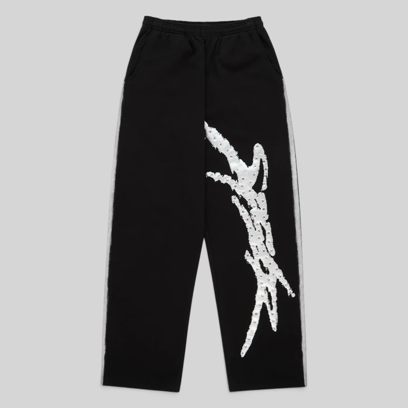 Front view of Sp5der Screaming Eagle sweatpants in black featuring iconic rhinestone logo and sprayed side stripe detail.