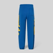 Back view of the Sp5der Beluga Sweatpants in TC Blue, showcasing signature yellow graphic prints on the legs.