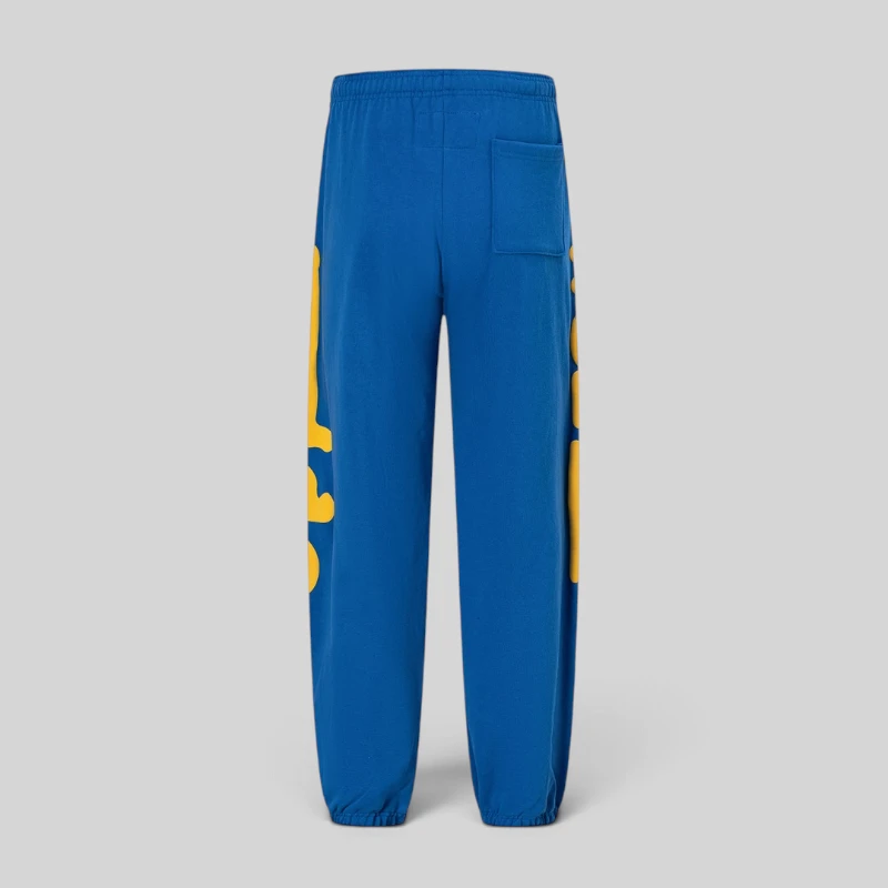 Back view of the Sp5der Beluga Sweatpants in TC Blue, showcasing signature yellow graphic prints on the legs.