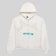 Front view of the Sp5der T&F Zip Up Hoodie in white, featuring signature graphic prints and a front zip closure.