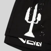 Close-up view of the Sp5der VAA double layer short in black, showcasing the pixelated cactus graphic print on front.