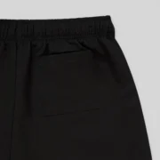 Close-up view of the back pocket detail on the black Sp5der VAA double-layer technical shorts for men and women.