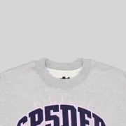 Close up view of the Sp5der Varsity Web Crewneck in grey featuring the bold branded graphic detail on the front chest.