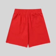 The back view of the red Sp5der Vvs sweatshorts featuring tonal rhinestone details and an elastic waist design.