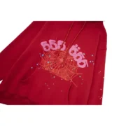 Close-up view of the bold red Sp5der Worldwide Angel Number 555 hoodie featuring a distressed web and star graphic print.