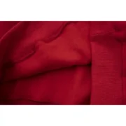 Close-up view of the premium red fabric texture on a Sp5der Worldwide Red Angel Number 555 Hoodie for men and women.