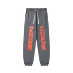 Front view of the grey Sp5der x Heroes and Villains unisex sweatpants featuring vibrant red graphic text on legs.
