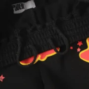 Close-up view of the Sp5der x UY Scuti Black Sweatshorts featuring the iconic Sp5der brand label and graphic print.