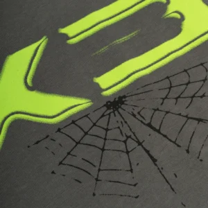 A close-up view of the neon green 5EX graphic and black spider web print on the Sp5der Heavyweight Essential Tee.