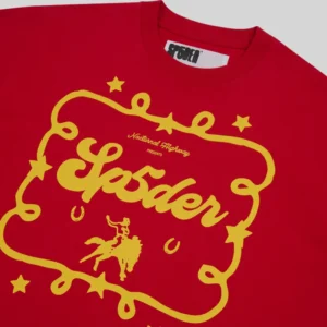 Close-up of the red Sp5der Rodeo Poster Tee featuring a yellow vintage graphic print and branding details.