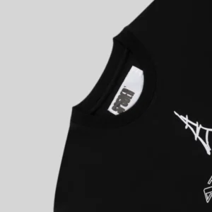 Close up of the black Sp5der Araignée Tee featuring the embroidered Eiffel Tower and Atlanta Paris graphic motif.