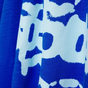 A detailed close-up shot of the blue fabric and white graphic print on the Sp5der Contrast Stitch Slub Tee shirt.