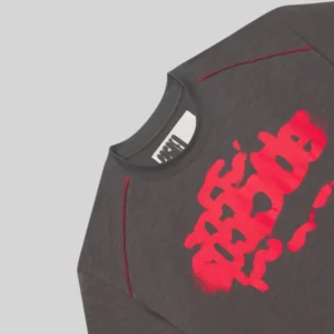 Close up of the grey Sp5der Contrast Stitch Slub Tee featuring red stitching and a bold red graphic print on the front.