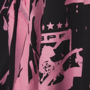 Close up of the black and pink Sp5der Jersey Overprint Tee showing the graphic logo design and brand detailing.