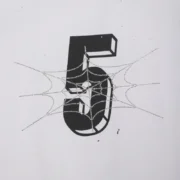 Close up of the Sp5der Pavouk Rhinestone Tee graphic featuring a black number five overlaid with a crystal spiderweb.