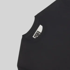 Close up view of the Sp5der Stacked T-shirt collar showcasing the branding on the inner neck label in black color.