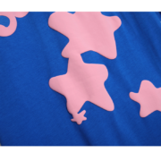Close-up of the blue Sp5der Worldwide Star T-shirt featuring pink star graphic details and premium cotton fabric.