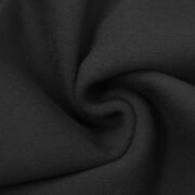 Close-up view of the premium fabric texture used for the black Sp5der OG Web Sweatpants, showcasing high quality.