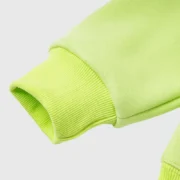 Close-up view of the ribbed sleeve cuff on the vibrant green Sp5der OG Web V2 streetwear hoodie for a premium look.