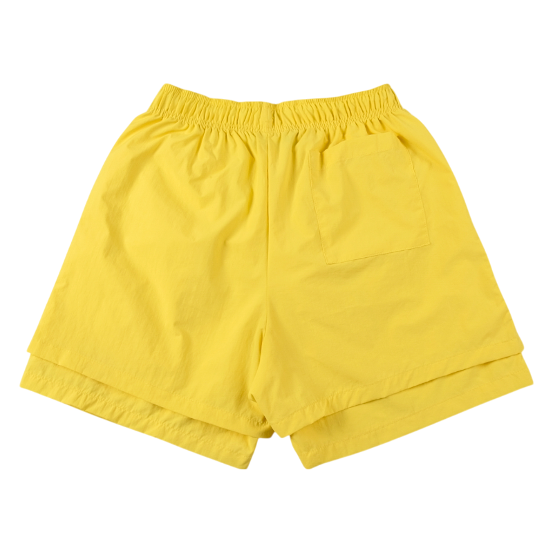 Yellow Sp5der OG Web double layer shorts showing the back view of the stylish summer streetwear apparel design.