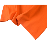 Close-up view of the premium orange cotton fabric texture used for the Sp5der Arach Tee streetwear t-shirt design.