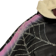 Sp5der Trucker Jacket featuring black denim, a unique rhinestone spider web graphic, and a white shearling collar.