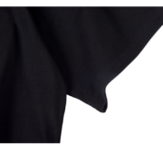 Close-up view of the premium cotton fabric texture used in the black Sp5der The Spot Tee streetwear garment.
