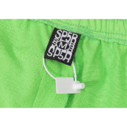Close-up view of the size M label on a pair of bright green Sp5der Websuit sweatpants with a security tag attached.