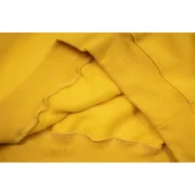Close-up view of the mustard-yellow hem detail on the high-quality Sp5der P*NK collaboration hoodie garment.