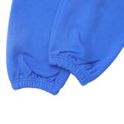 Close-up view of the royal blue Sp5der Websuit sweatpants, highlighting the detailed elasticated cuff and fabric hem.