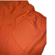 Detailed view of the orange back pocket on the Sp5der Worldwide Sweat Short for a casual streetwear look.