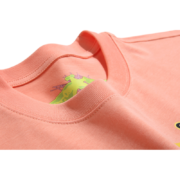 Close-up view of a peach-colored Sp5der print t-shirt showcasing the neck label detail and unique graphic design.
