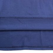 A close-up view of the navy blue hem and premium cotton fabric detail of the Sp5der 5 Baby Tee streetwear shirt.
