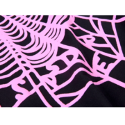 Close-up view of the pink spider web graphic print on a black SP5DER Worldwide Web Tee shirt fabric texture.