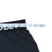 Measurement detail of the Sp5der unisex Vista running short waistband with a tape measure showing sizing specifications