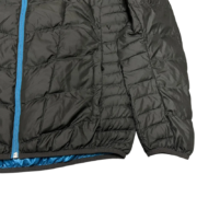 Close up of the black Sp5der Men’s Light Down Puffer Jacket featuring blue zipper details and quilted construction.